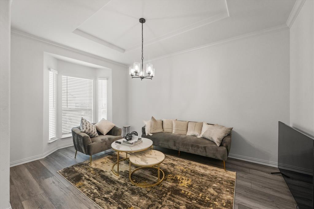 1111 Alaska Drive Forney, TX 75126 - Photo 30 of 30 a living room with furniture and a chandelier