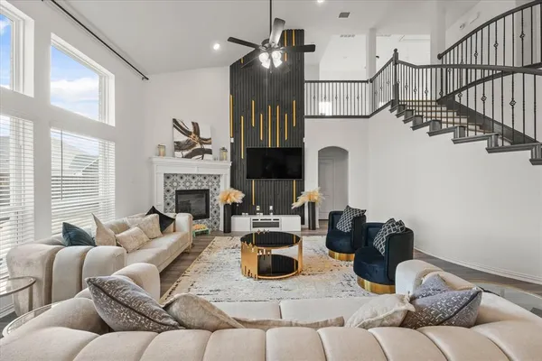 a living room with furniture fireplace and flat screen tv