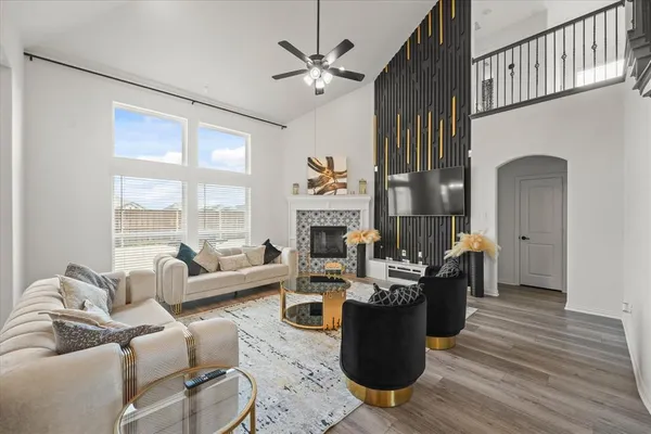 a living room with fireplace furniture and a large window