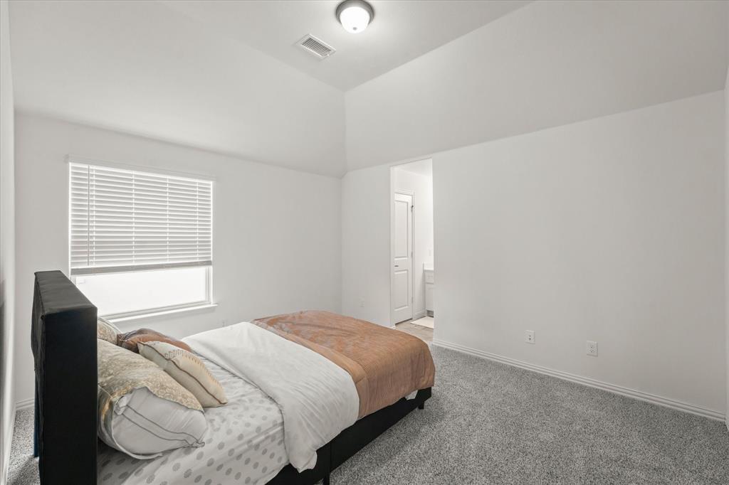 1111 Alaska Drive Forney, TX 75126 - Photo 10 of 30 a bedroom with a bed and a window