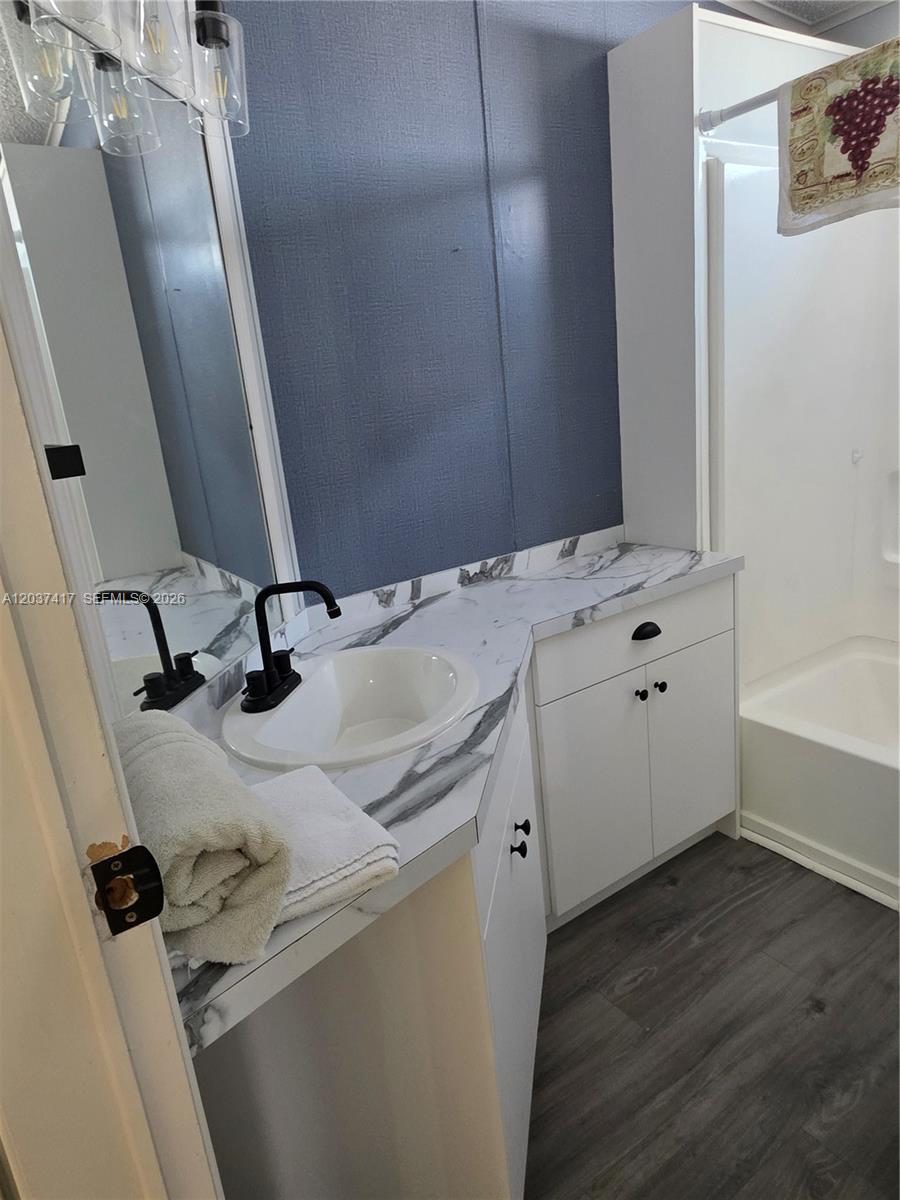 17350 Southwest 232nd Street, Unit 47 Miami, FL 33170 - Photo 8 of 9 a bathroom with a sink and a mirror