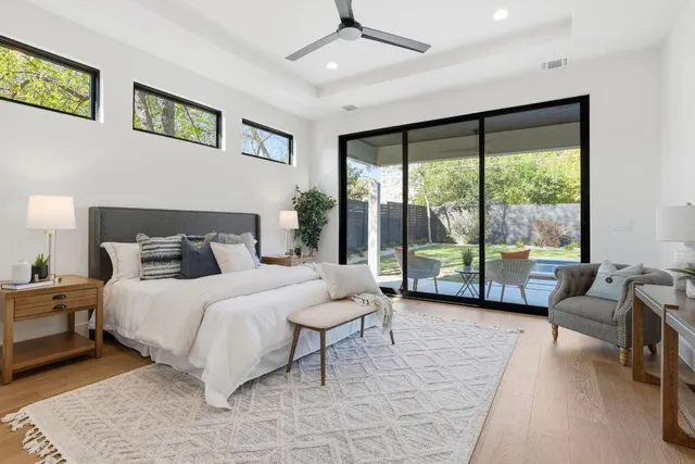 a bedroom with a bed and a large window