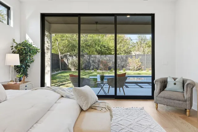 a living room with furniture and a floor to ceiling window