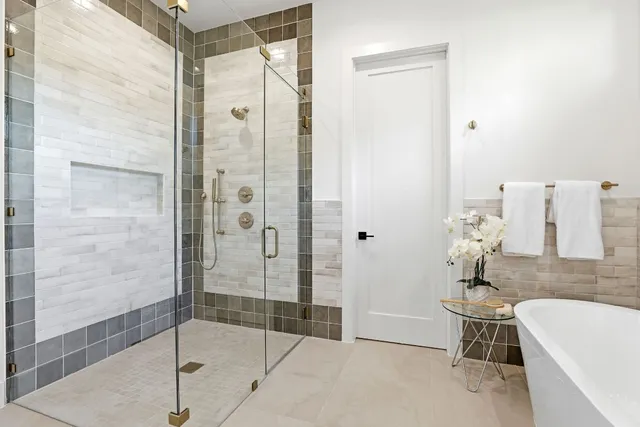 a bathroom with a bathtub and a shower