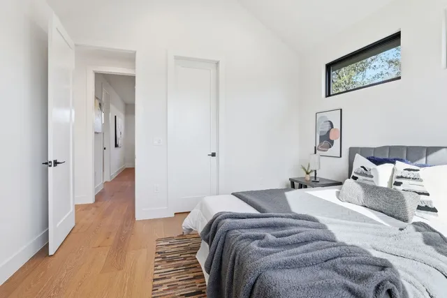 a bedroom with a bed and a painting on the wall