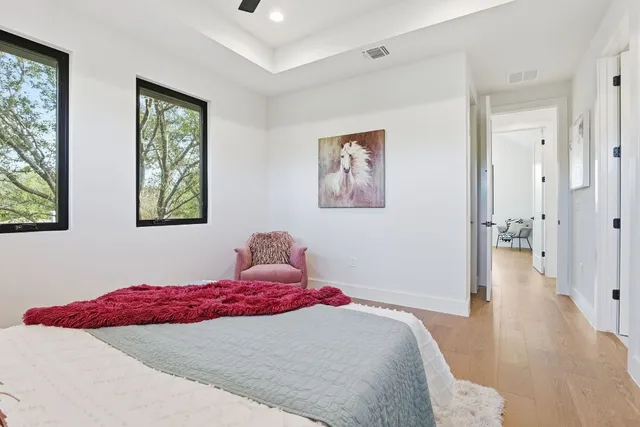 a bedroom with a bed and a painting on the wall