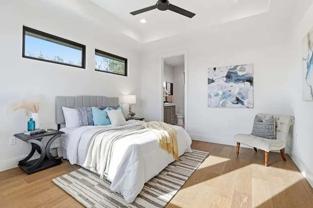 a bedroom with a bed and a chandelier