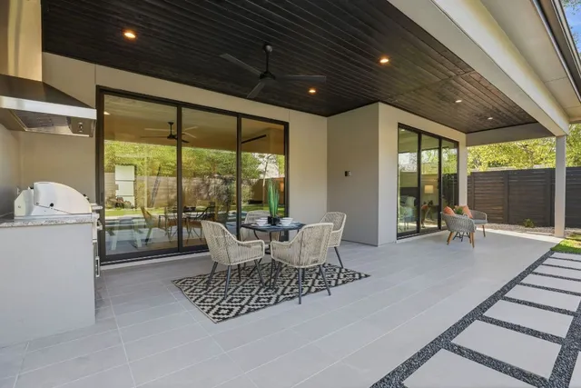 a living room with furniture and large windows