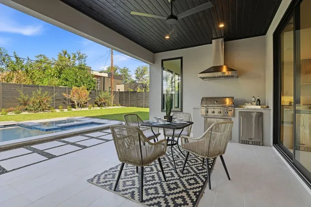 a view of a dining room with furniture a chandelier and wooden floor