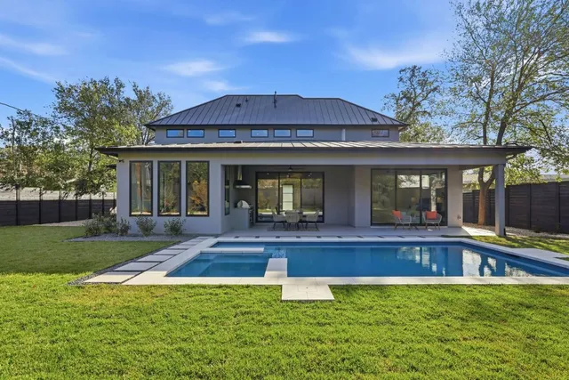 a view of a house with a yard and sitting area