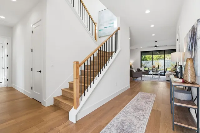 a view of entryway and hall with wooden floor