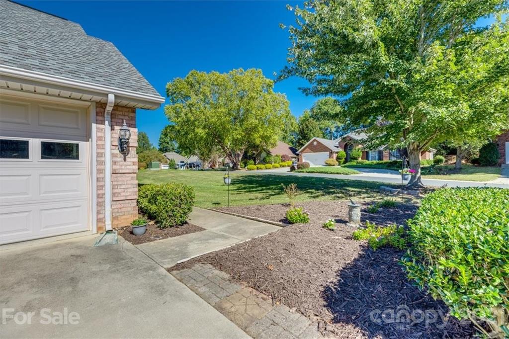 704 Beechnut Court Fort Mill, SC 29708 - Photo 2 of 46 a view of a garden with a house in the background
