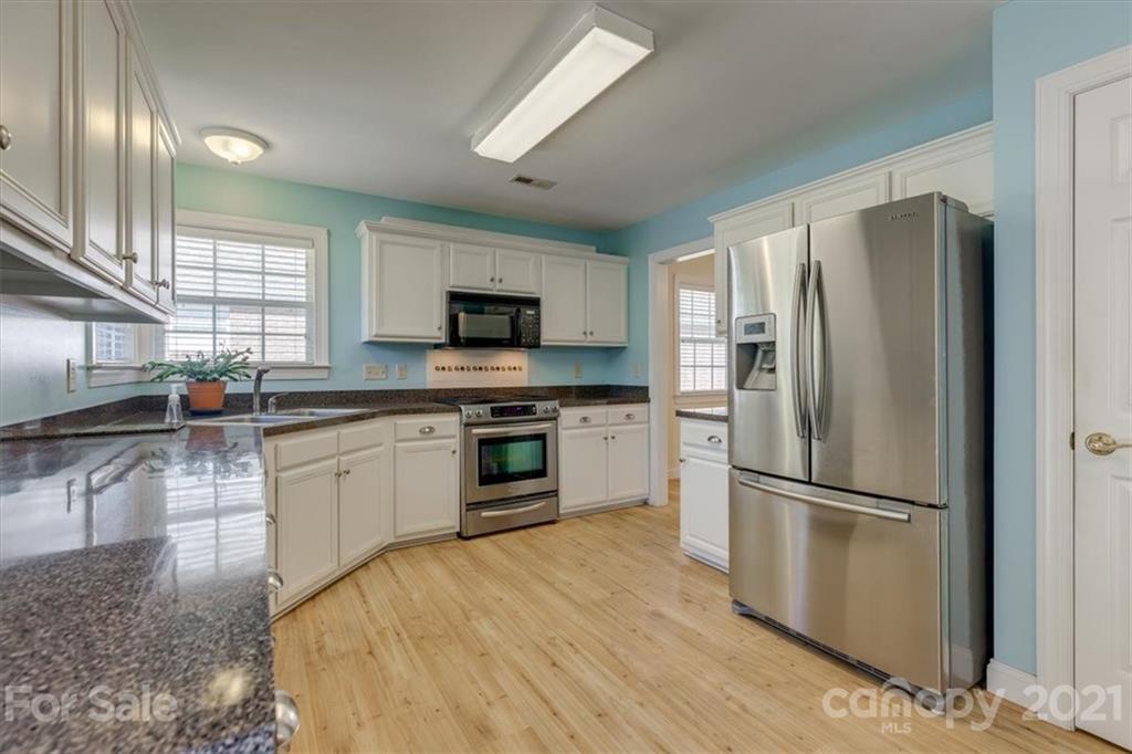 704 Beechnut Court Fort Mill, SC 29708 - Photo 13 of 46 a kitchen with granite countertop a refrigerator stove and sink