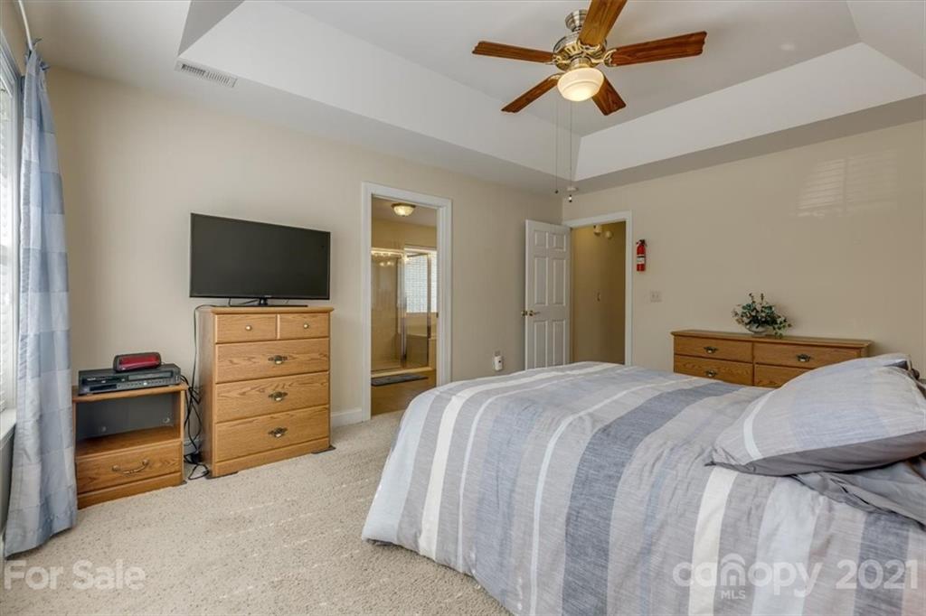 704 Beechnut Court Fort Mill, SC 29708 - Photo 29 of 46 a bedroom with a bed and a flat tv screen on dresser