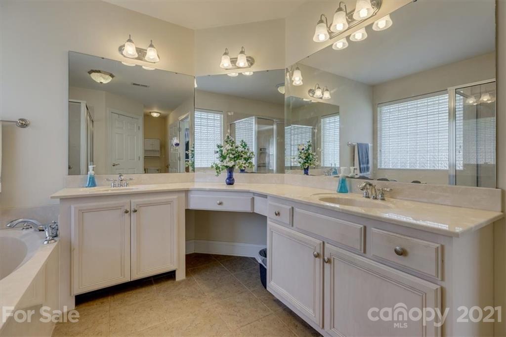 704 Beechnut Court Fort Mill, SC 29708 - Photo 31 of 46 a spacious bathroom with a double vanity sink a mirror a bathtub and vanity
