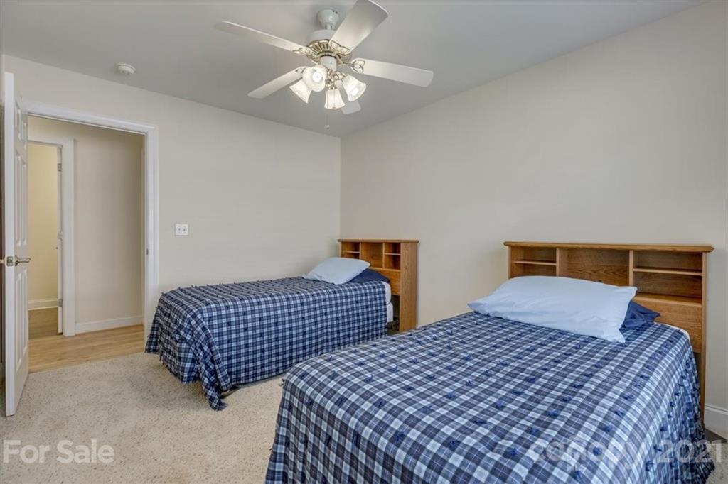 704 Beechnut Court Fort Mill, SC 29708 - Photo 34 of 46 a bedroom with two beds and a chandelier