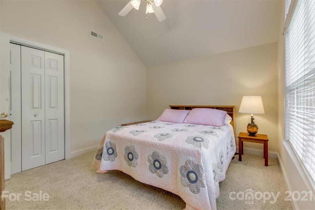 704 Beechnut Court Fort Mill, SC 29708 - Photo 36 of 46 a utility room with a bed and a chandelier