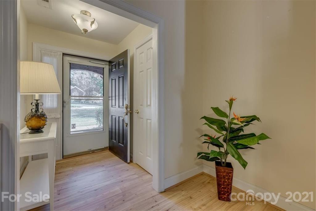 704 Beechnut Court Fort Mill, SC 29708 - Photo 5 of 46 a view of a hallway with wooden floor and a potted plant