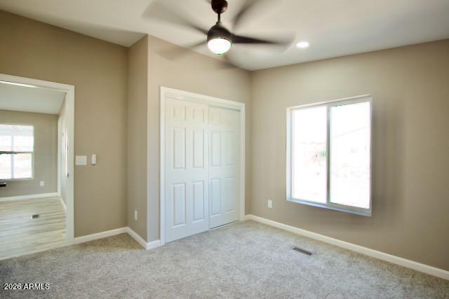 1470 South Bowman Road Apache Junction, AZ 85119 - Photo 29 of 56 an empty room with windows and fan