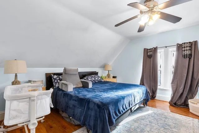 a spacious bedroom with a bed and a chandelier