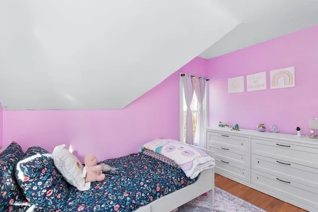 a bedroom with a bed and a dresser in it