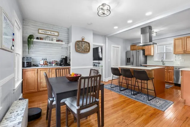 a dining room with furniture and wooden floor