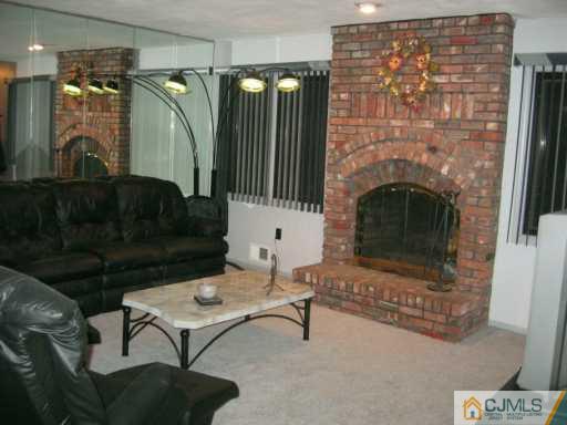 5 Chelsea Court Sayreville, NJ 08859 - Photo 3 of 8 a living room with furniture and a fireplace