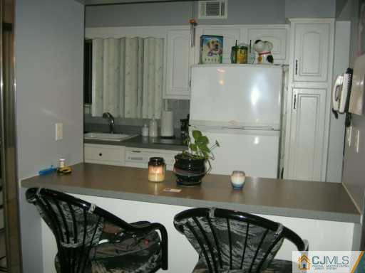 5 Chelsea Court Sayreville, NJ 08859 - Photo 5 of 8 a kitchen with a table and chairs