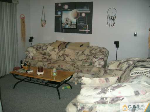 5 Chelsea Court Sayreville, NJ 08859 - Photo 7 of 8 a bedroom with a bed and a painting on the wall