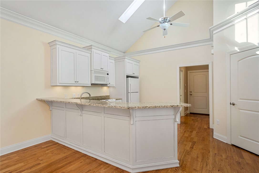 16 Oleander Drive Anderson, SC 29621 - Photo 13 of 37 Vast vaulted ceilings complement an inviting kitchen island with ample space for dining.