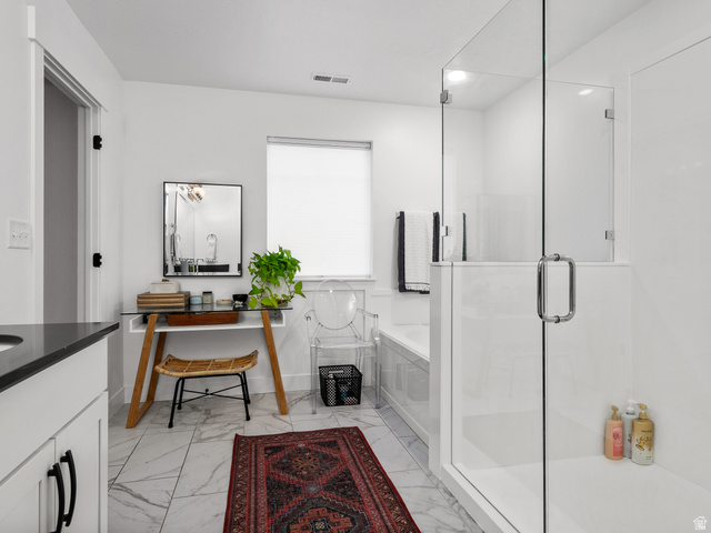 627 South Meade Street Mapleton, UT 84664 - Photo 47 of 48 Bathroom featuring a glass-enclosed shower, white tile flooring with gray veining, white bathtub surround, vanity with dark countertop, and white walls