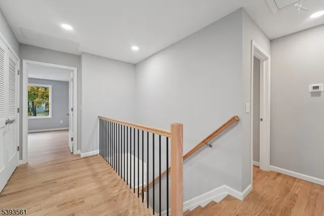 a view of a hallway with wooden floor and entryway