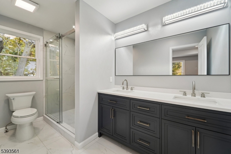 120 Addison Street Boonton, NJ 07005 - Photo 18 of 44 a spacious bathroom with a double vanity sink toilet and a mirror