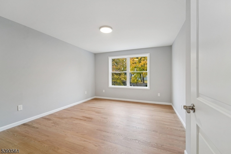 120 Addison Street Boonton, NJ 07005 - Photo 22 of 44 an empty room with wooden floor and windows