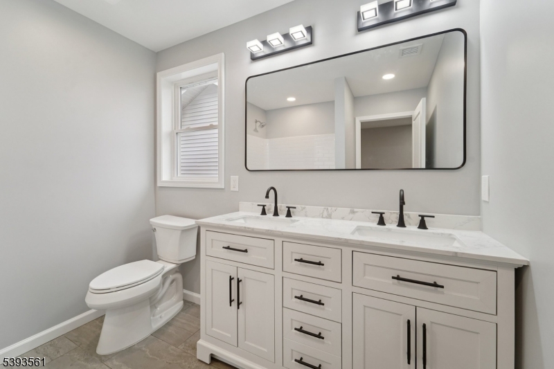 120 Addison Street Boonton, NJ 07005 - Photo 23 of 44 a bathroom with a toilet sink vanity and mirror