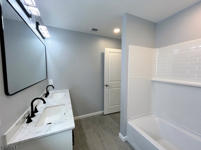 120 Addison Street Boonton, NJ 07005 - Photo 25 of 44 a bathroom with a tub sink and mirror