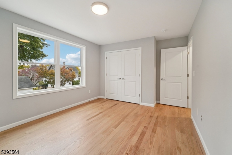120 Addison Street Boonton, NJ 07005 - Photo 29 of 44 an empty room with wooden floor and windows