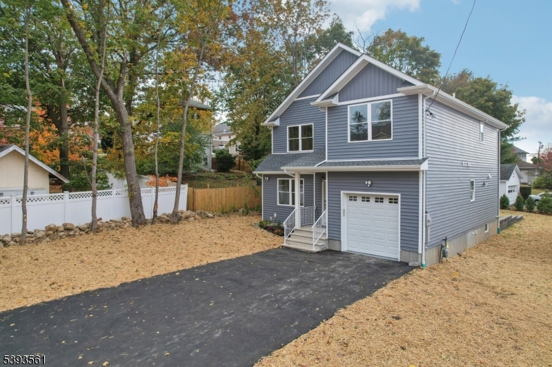 120 Addison Street Boonton, NJ 07005 - Photo 4 of 44 a front view of a house with a yard and garage