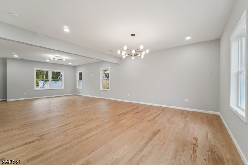 120 Addison Street Boonton, NJ 07005 - Photo 7 of 44 a view of an empty room with wooden floor and a window