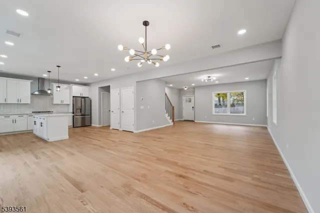 a view of an empty room with a window and fireplace