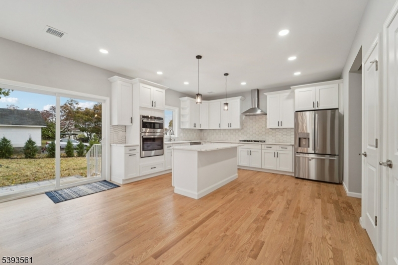 120 Addison Street Boonton, NJ 07005 - Photo 9 of 44 a kitchen with white cabinets and stainless steel appliances