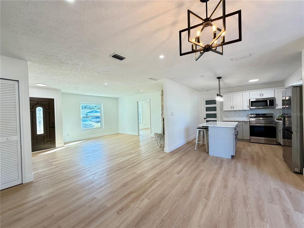 a kitchen with stainless steel appliances granite countertop a wooden floors