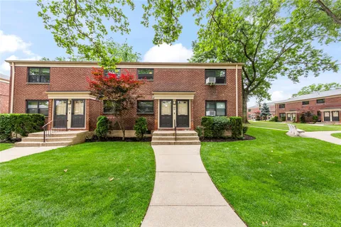a front view of a house with a garden and porch