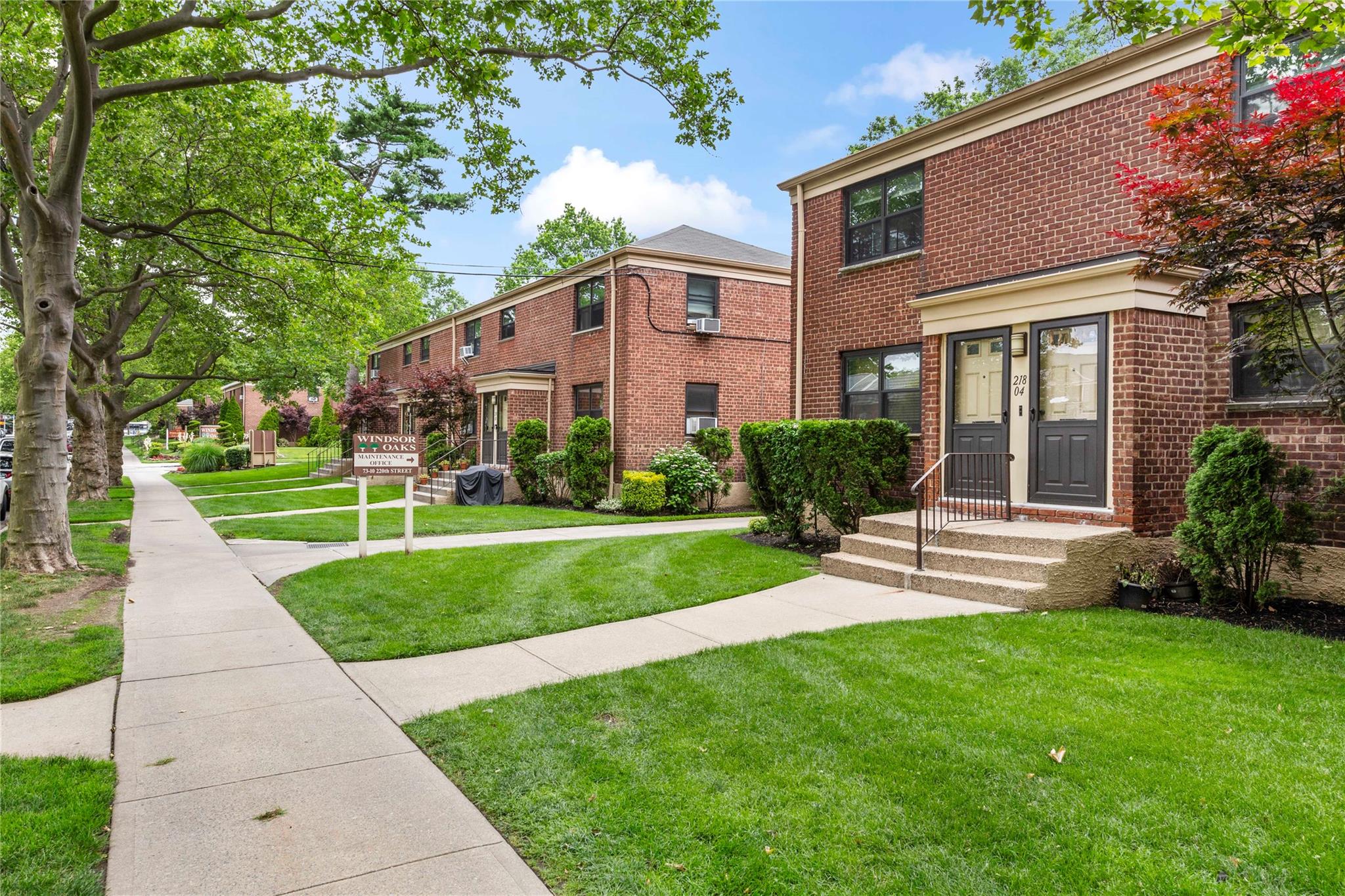 218-02 73rd Avenue, Unit UPPR Queens, NY 11364 - Photo 19 of 19 a front view of a house with a yard and plants