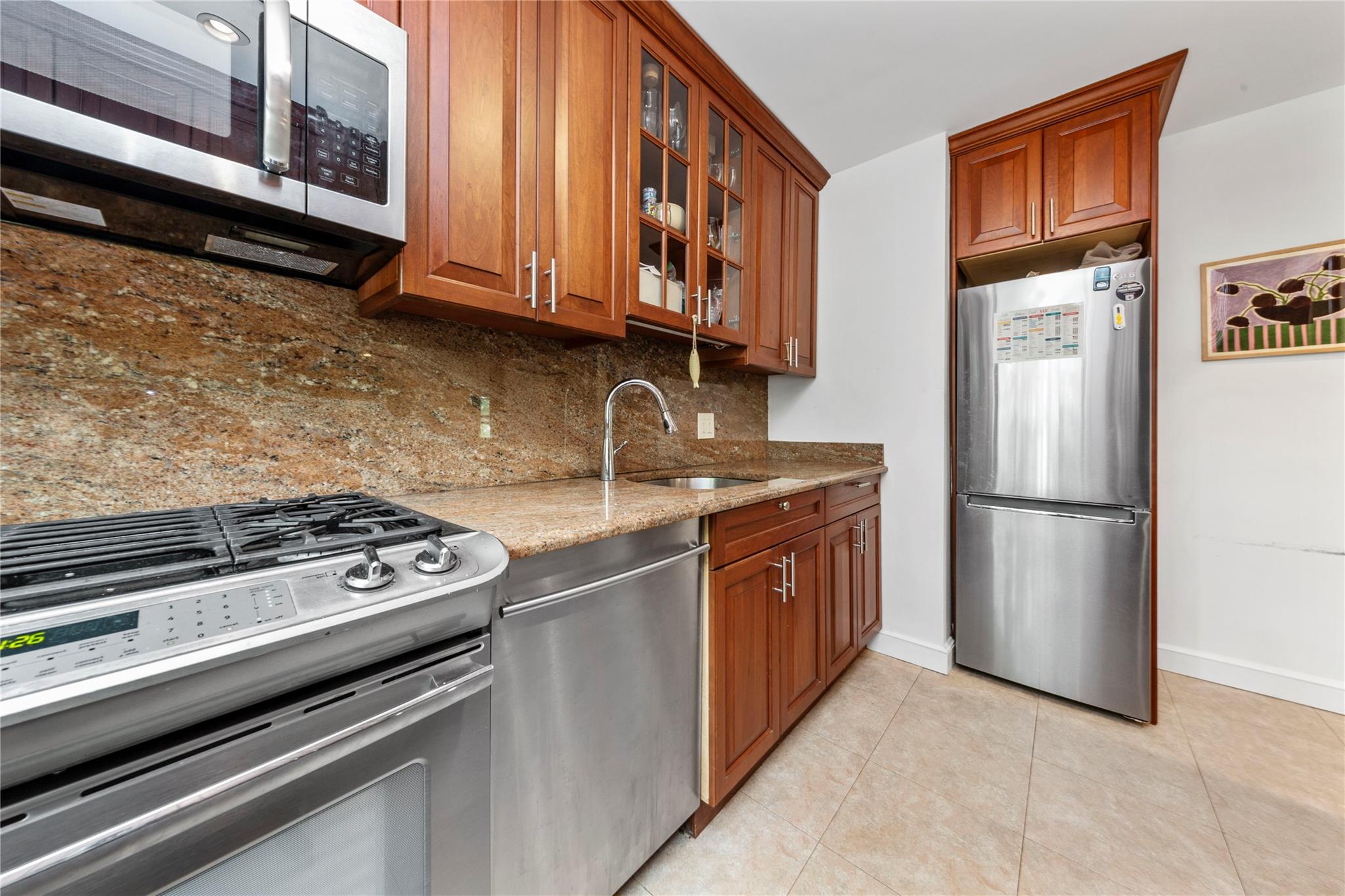 218-02 73rd Avenue, Unit UPPR Queens, NY 11364 - Photo 2 of 19 a kitchen with stainless steel appliances granite countertop a refrigerator stove and a sink