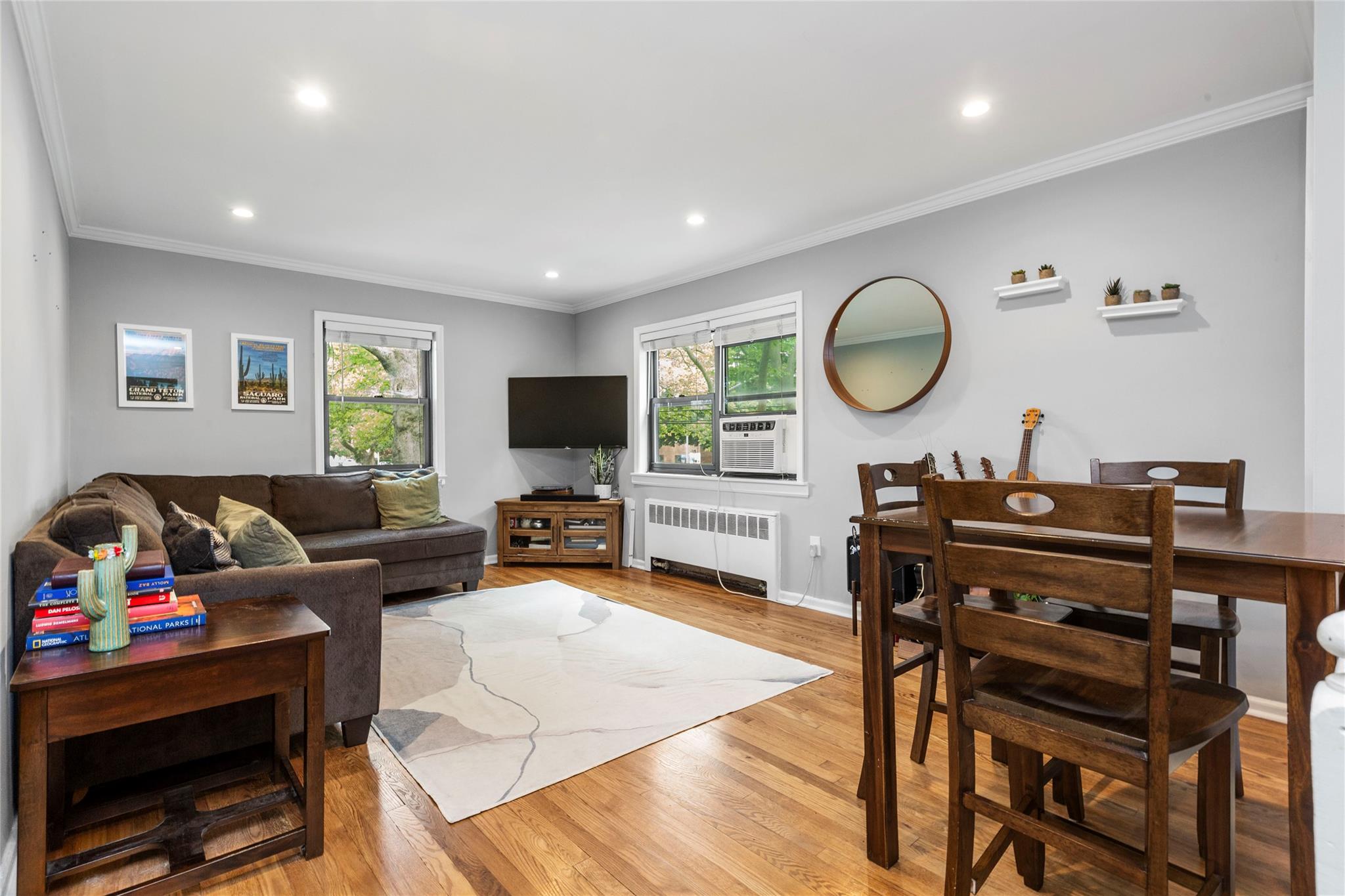 218-02 73rd Avenue, Unit UPPR Queens, NY 11364 - Photo 7 of 19 a living room with furniture a flat screen tv and a window