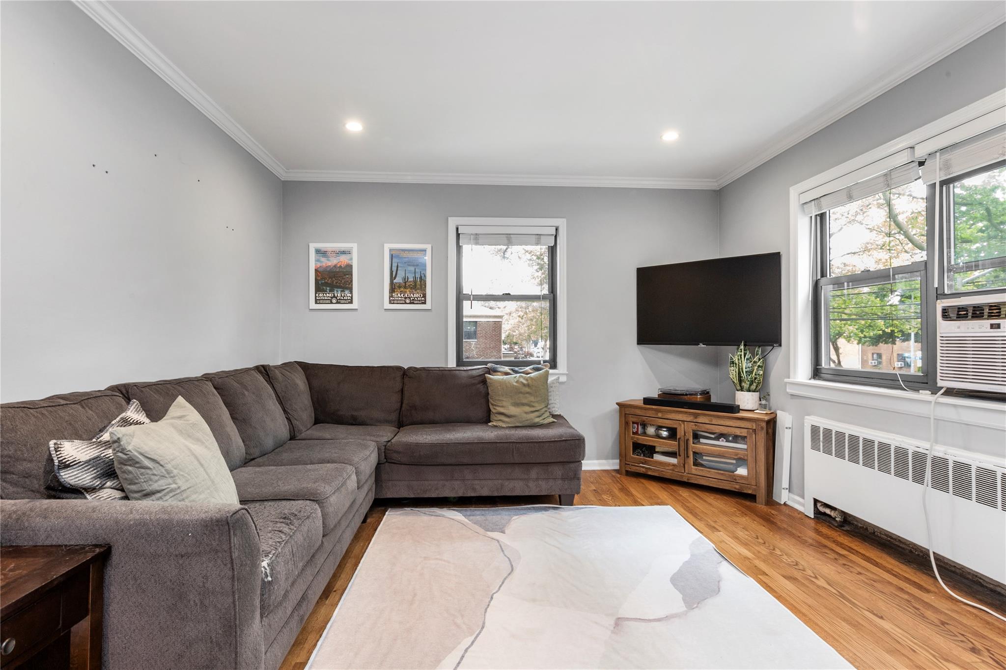 218-02 73rd Avenue, Unit UPPR Queens, NY 11364 - Photo 8 of 19 a living room with furniture and a flat screen tv