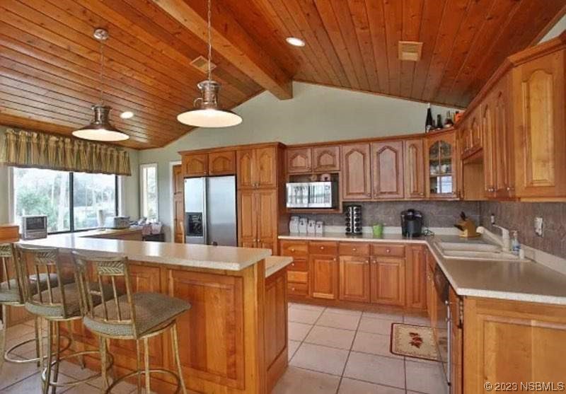1012 South Riverside Drive Edgewater, FL 32132 - Photo 18 of 31 a kitchen with granite countertop a sink a counter top space and cabinets