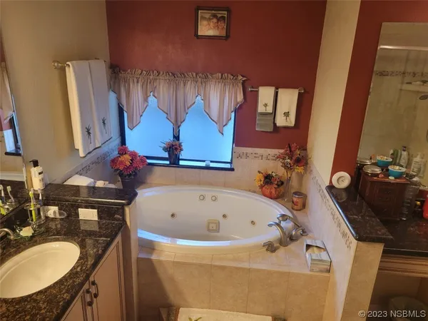 a view of a building with entryway and potted plants