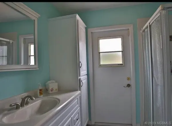a bedroom with a bed dresser and a window